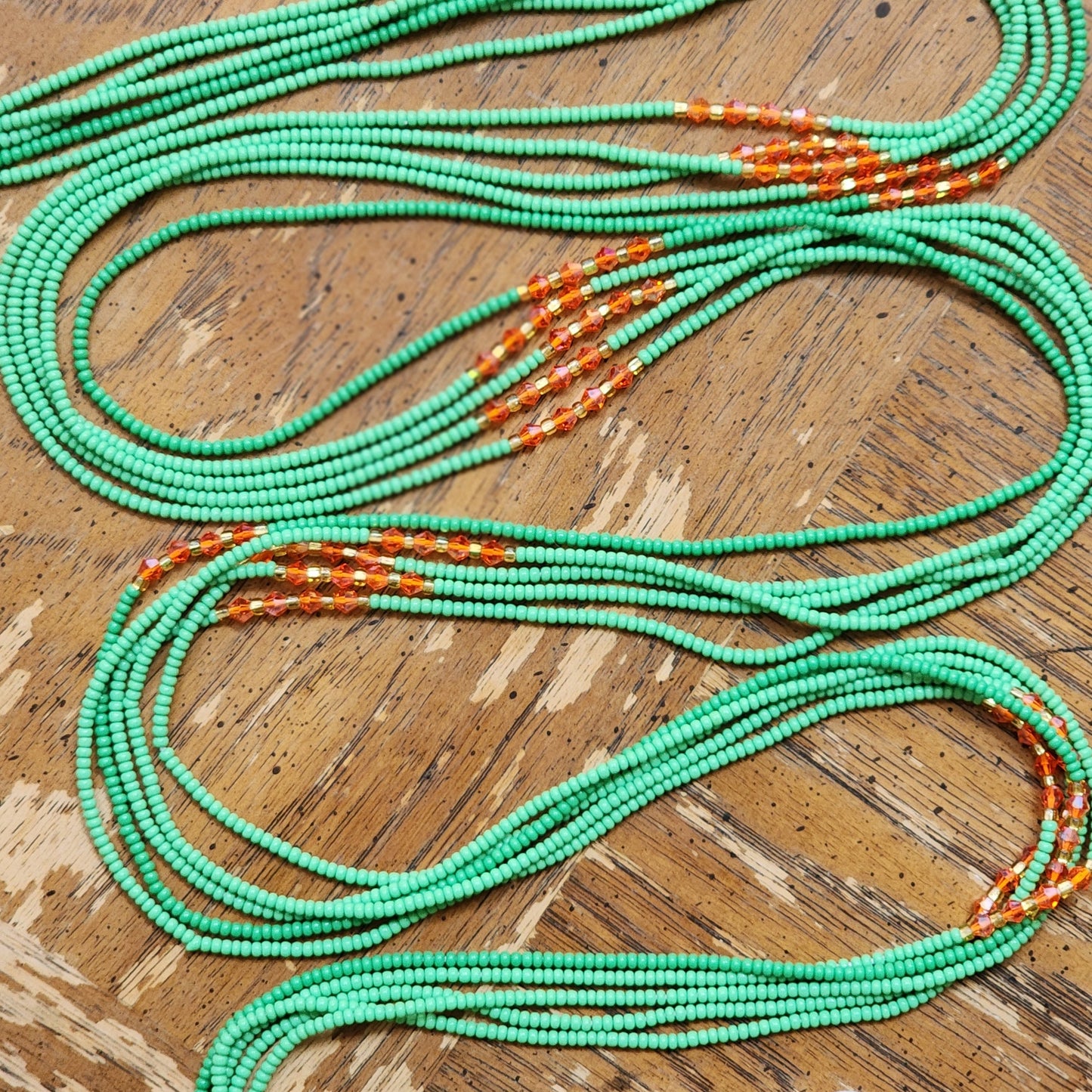 Green Premium handmade waistbeads with orange iridescent crystals