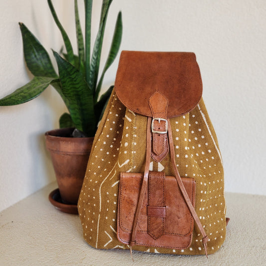Mustard yellow mudcloth backpack with brown leather