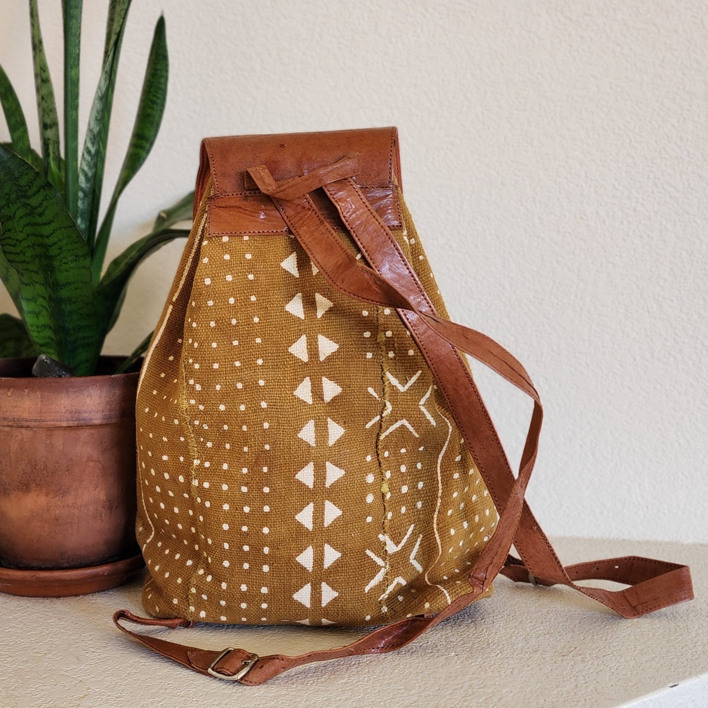 Mustard yellow mudcloth backpack with brown leather