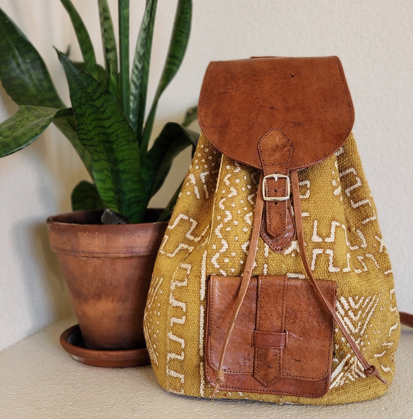 Mustard yellow mudcloth backpack with brown leather