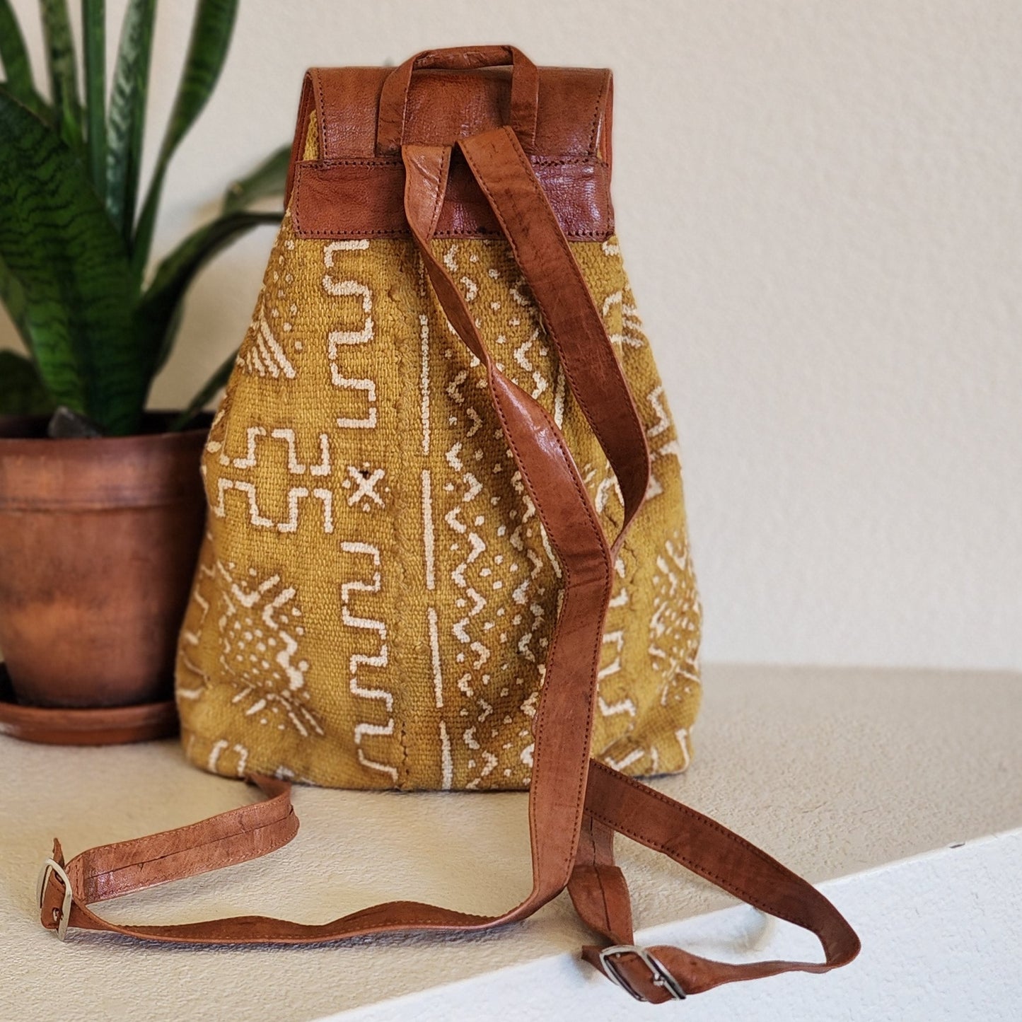 Mustard yellow mudcloth backpack with brown leather