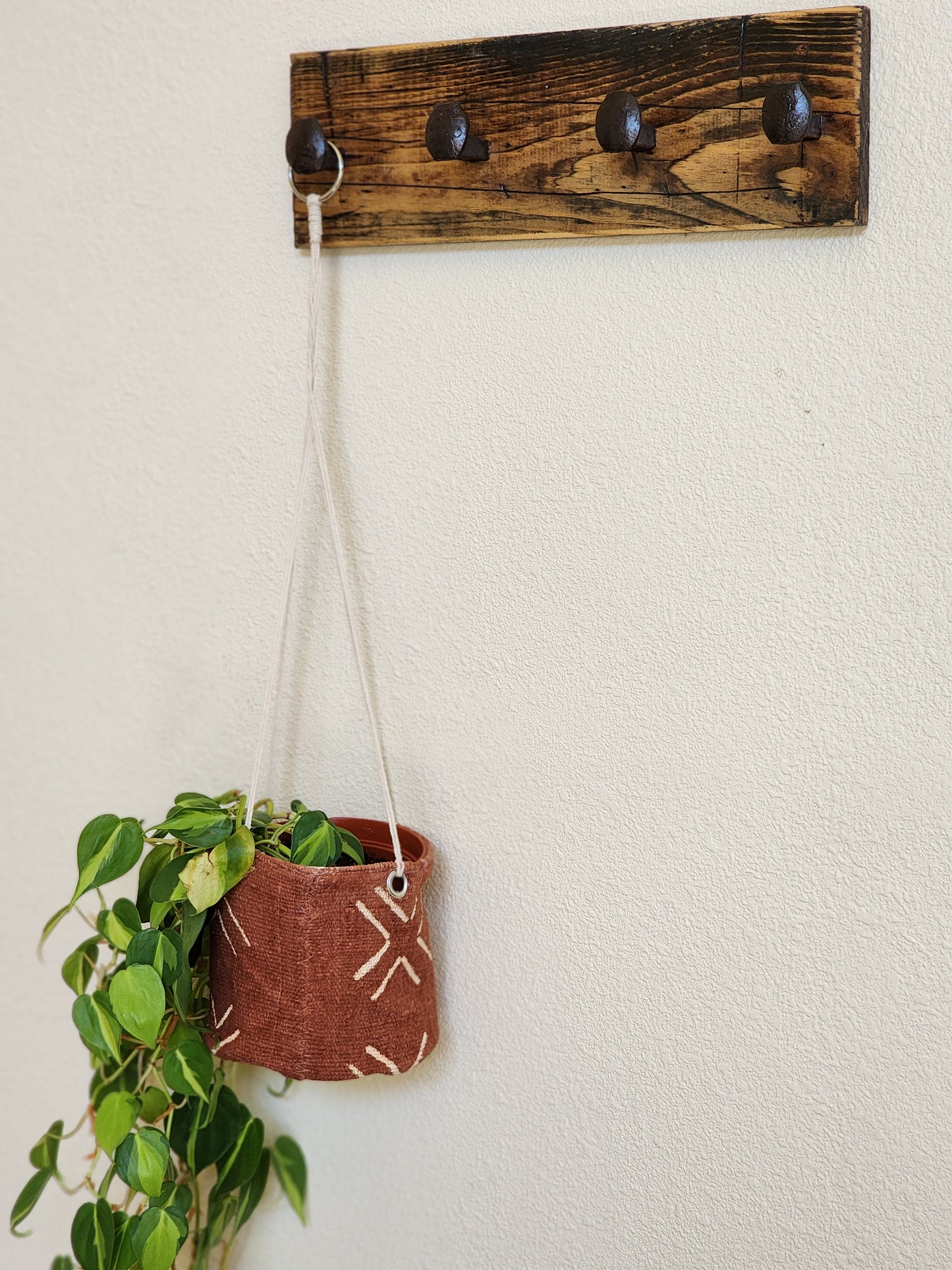 Rust colored mudcloth hanging plant basket