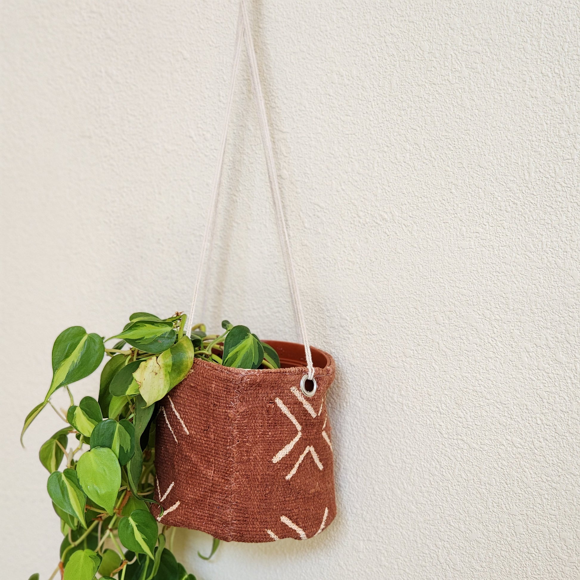 Rust colored mudcloth hanging plant basket