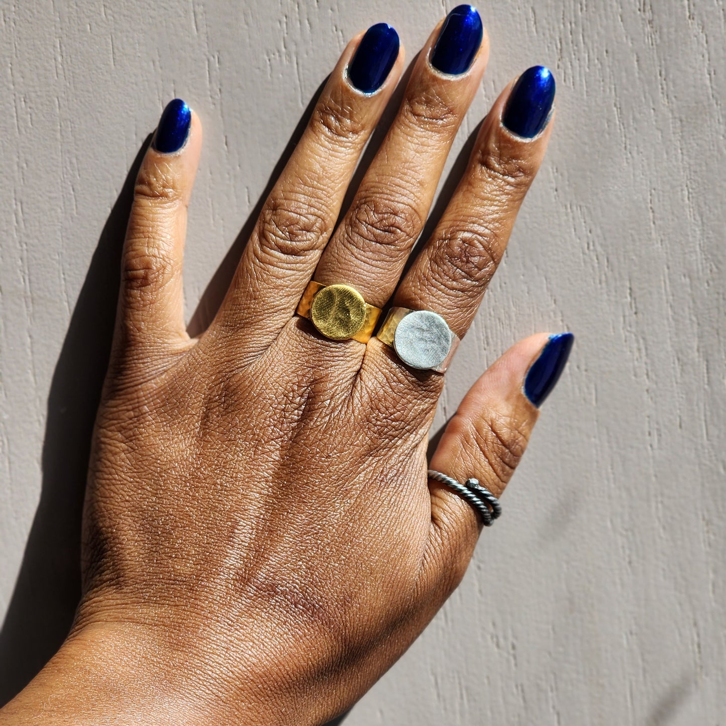 Model wearing yellow and silver plated brass, adjustable rings